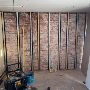 In-progress photo showing the process of dry-lining an old wall. In-progress photo showing the process of dry-lining an old wall.